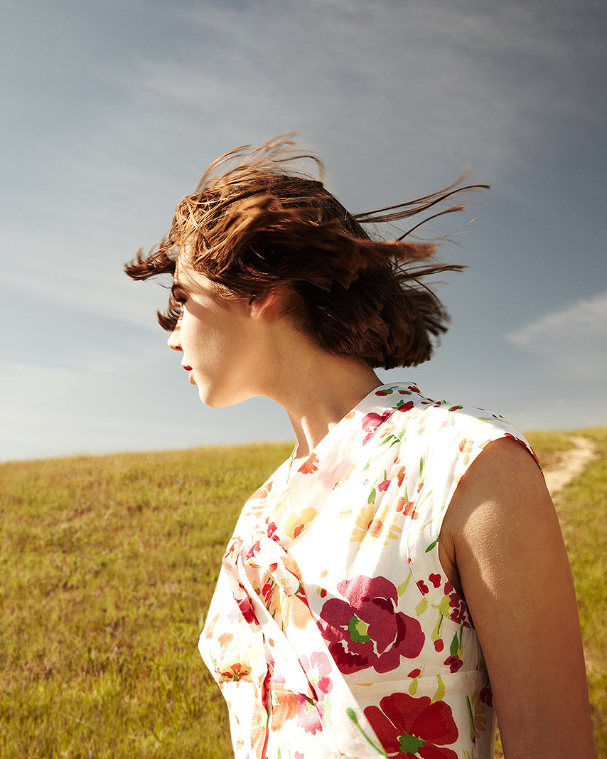 Teenage girl looking away with her hair being blown by wind